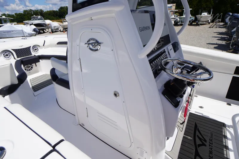 Slide: The Image of 2025 Tidewater 272 LXF boat interior with steering wheel and control panel. - 57