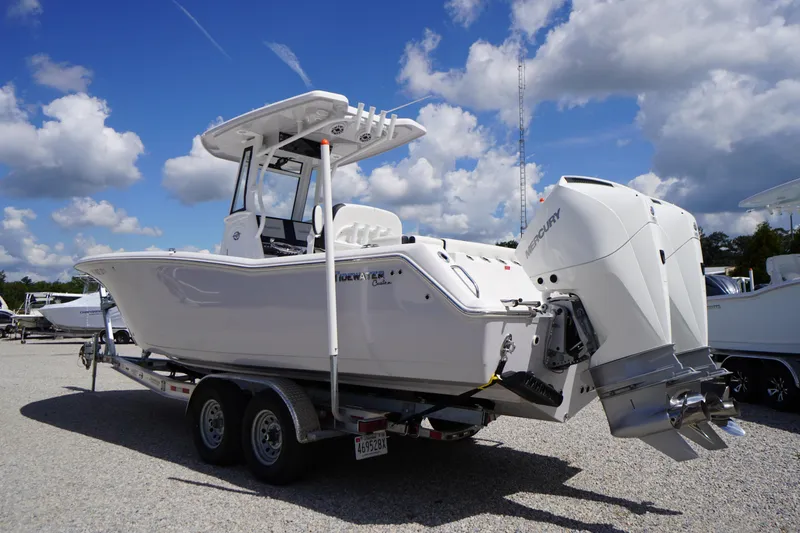 Slide: The Image of 2025 Tidewater 272 LXF boat on trailer under blue sky. - 6