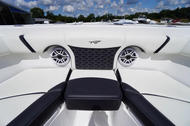 Slide: The Image of 2025 Tidewater 272 LXF boat interior with stylish seating and speakers. - 69