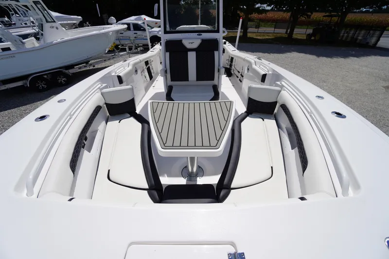 Slide: The Image of 2025 Tidewater 272 LXF boat interior with sleek seating and modern table design. - 74
