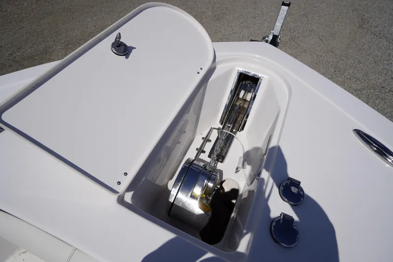 Slide: The Image of 2025 Tidewater 272 LXF boat anchor compartment with winch and storage hatch. - 77
