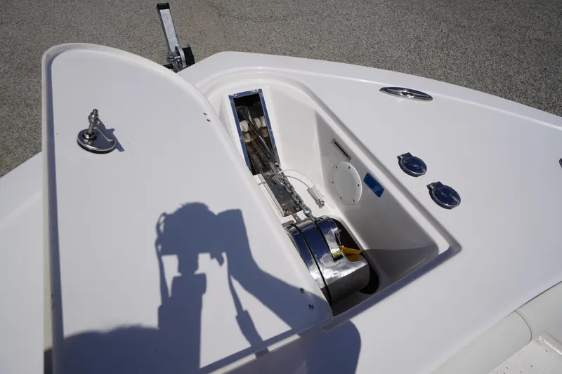 Slide: The Image of 2025 Tidewater 272 LXF boat anchor compartment with winch and chain. - 78