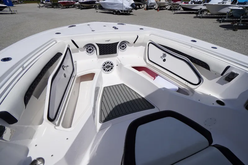 Slide: The Image of 2025 Tidewater 272 LXF boat interior with storage compartments and speakers. - 79