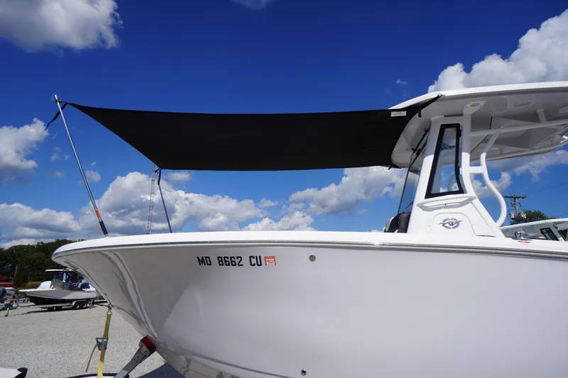 Slide: The Image of 2025 Tidewater 272 LXF boat with canopy under a clear blue sky. - 85