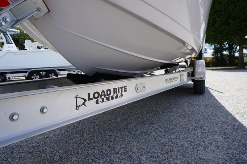 Slide: The Image of 2025 Tidewater 272 LXF boat on Load Rite Elite trailer, parked on gravel. - 87