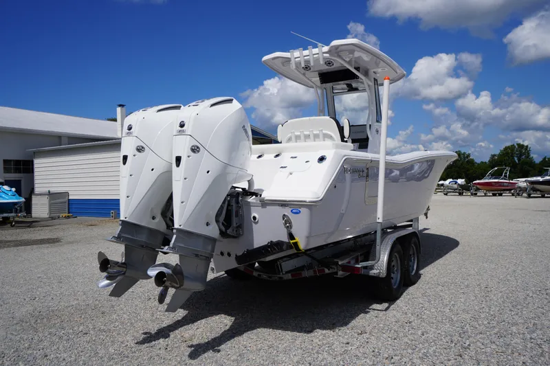 Slide: The Image of 2025 Tidewater 272 LXF boat with dual engines on a trailer under a blue sky. - 9
