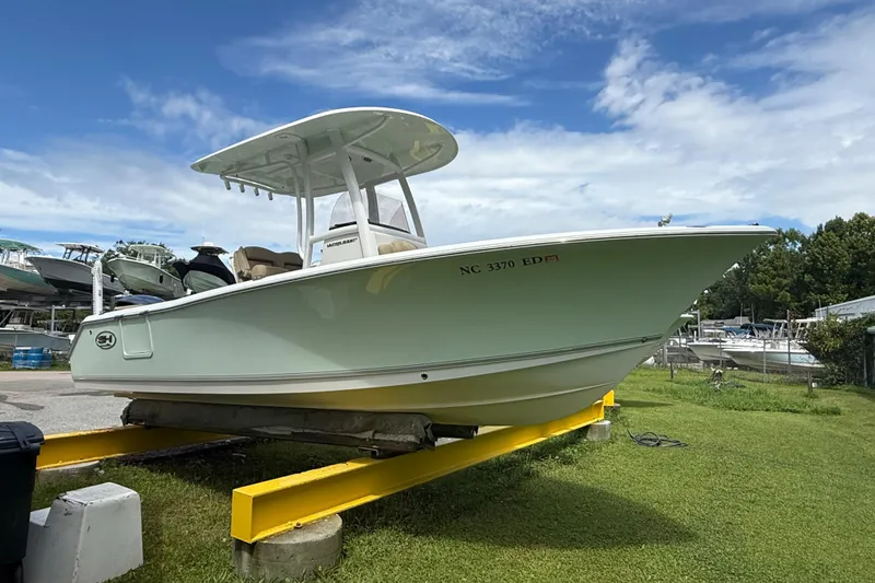The Image of 2016 Sea Hunt Ultra 235 SE boat on display under a clear blue sky. - 1