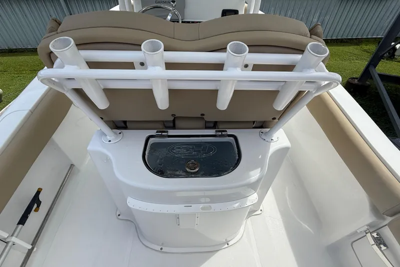 Slide: The Image of 2016 Sea Hunt Ultra 235 SE boat interior with rod holders and storage compartment. - 11