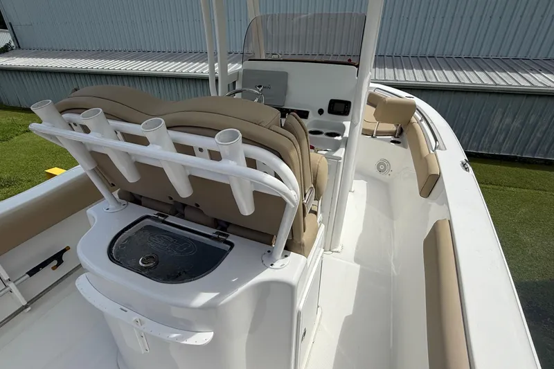 Slide: The Image of 2016 Sea Hunt Ultra 235 SE boat interior with seating and rod holders. - 12