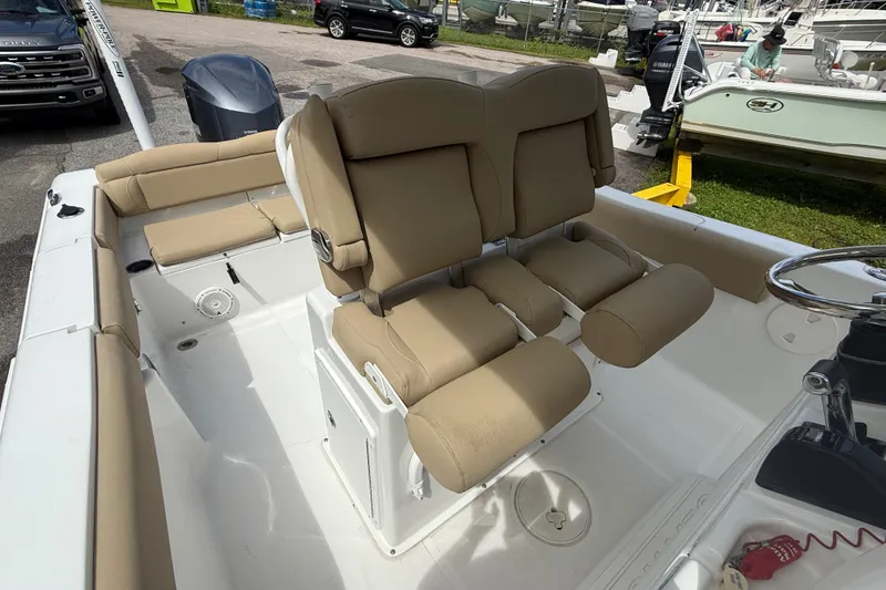 Slide: The Image of 2016 Sea Hunt Ultra 235 SE boat interior with tan seating and steering wheel. - 13