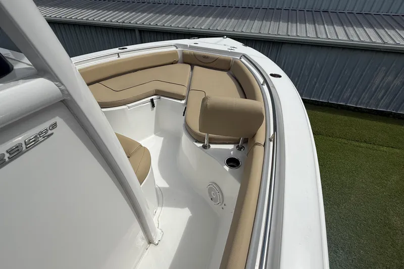 Slide: The Image of 2016 Sea Hunt Ultra 235 SE boat interior with beige seating and stainless steel details. - 14