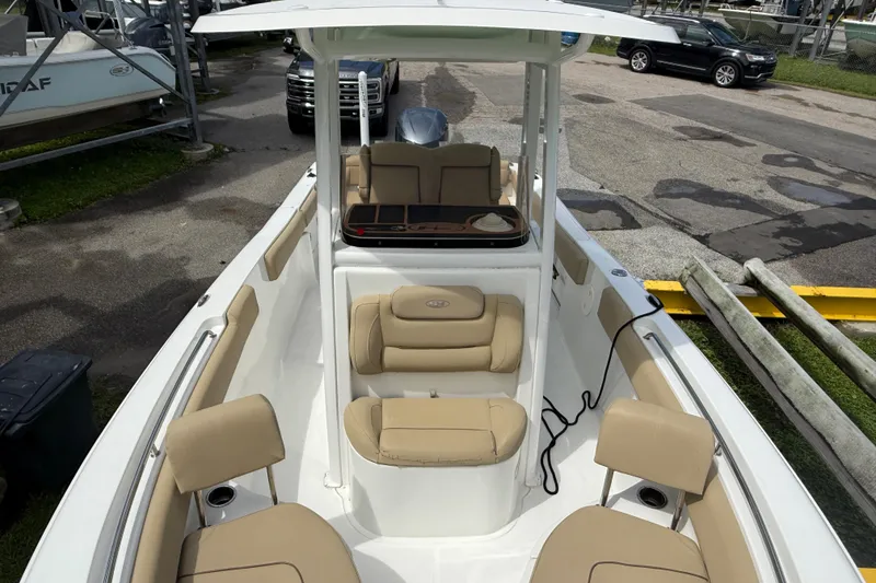 Slide: The Image of 2016 Sea Hunt Ultra 235 SE boat with beige seating and center console. - 16