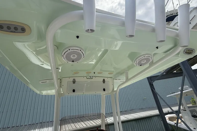 Slide: The Image of 2016 Sea Hunt Ultra 235 SE boat's underside view with speakers and rod holders. - 17