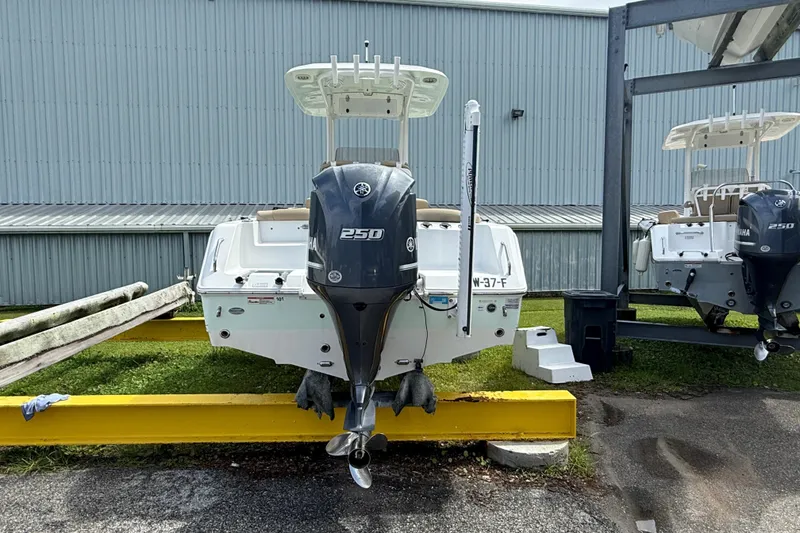 Slide: The Image of 2016 Sea Hunt Ultra 235 SE boat with Yamaha 250 engine, parked outdoors. - 5