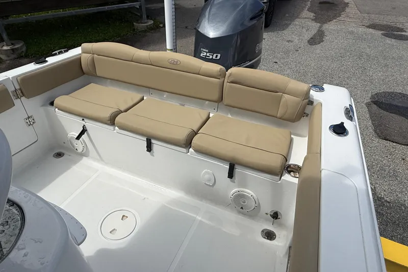 Slide: The Image of 2016 Sea Hunt Ultra 235 SE boat interior with beige cushioned seating. - 9
