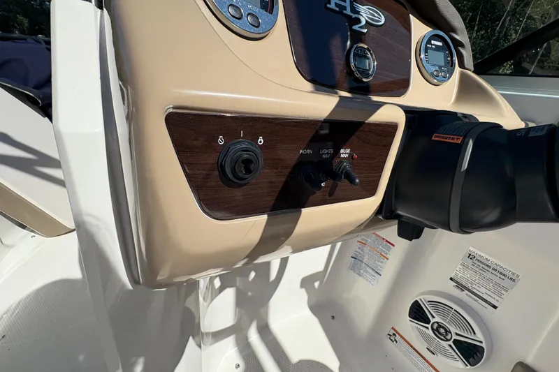 Slide: The Image of 2019 Chaparral 18 H2O Sport dashboard with controls and gauges. - 11