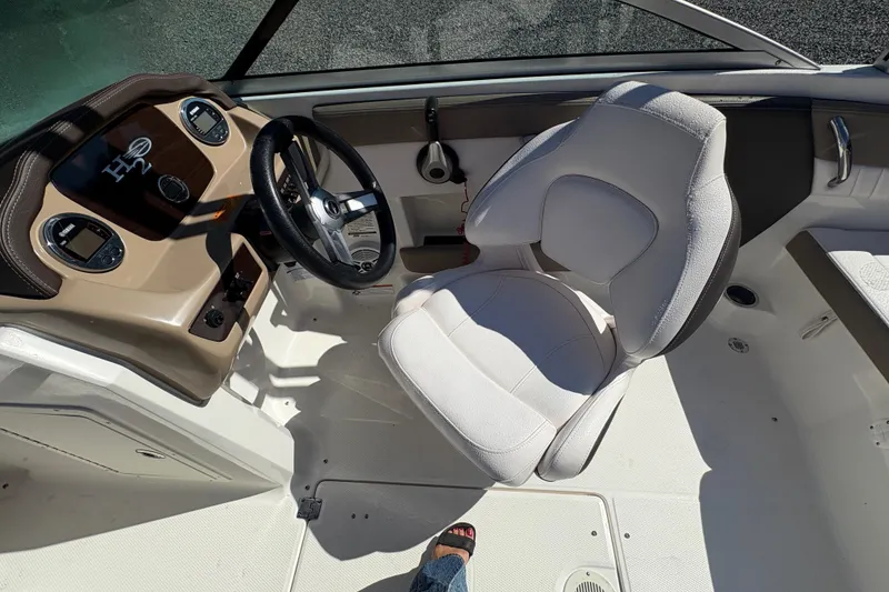 Slide: The Image of 2019 Chaparral 18 H2O Sport boat cockpit with steering wheel and seat. - 13