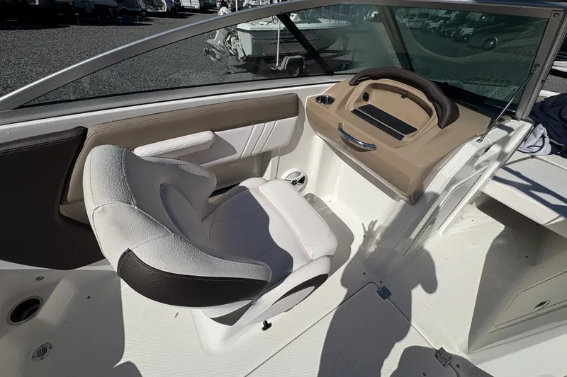 Slide: The Image of 2019 Chaparral 18 H2O Sport boat interior with steering wheel and seating. - 14
