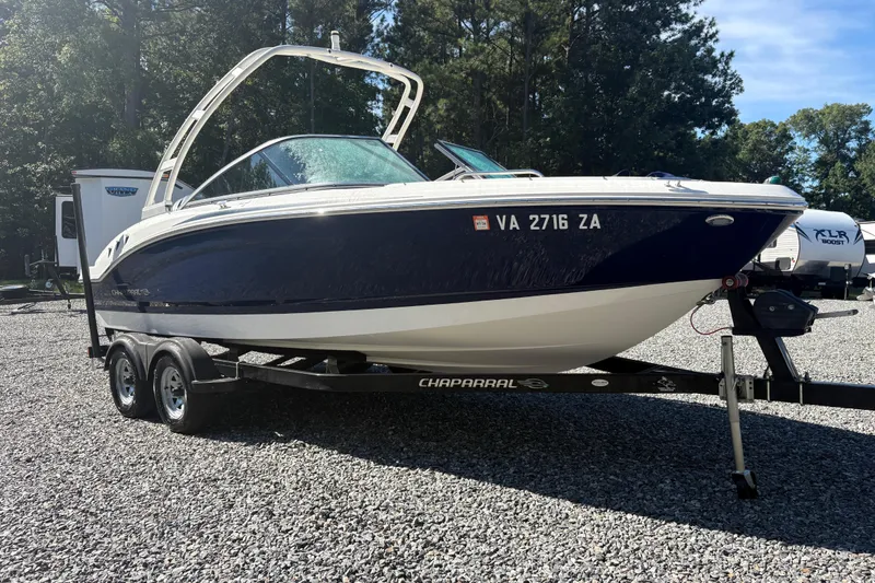 Slide: The Image of 2019 Chaparral 18 H2O Sport boat on trailer, parked on gravel lot. - 6