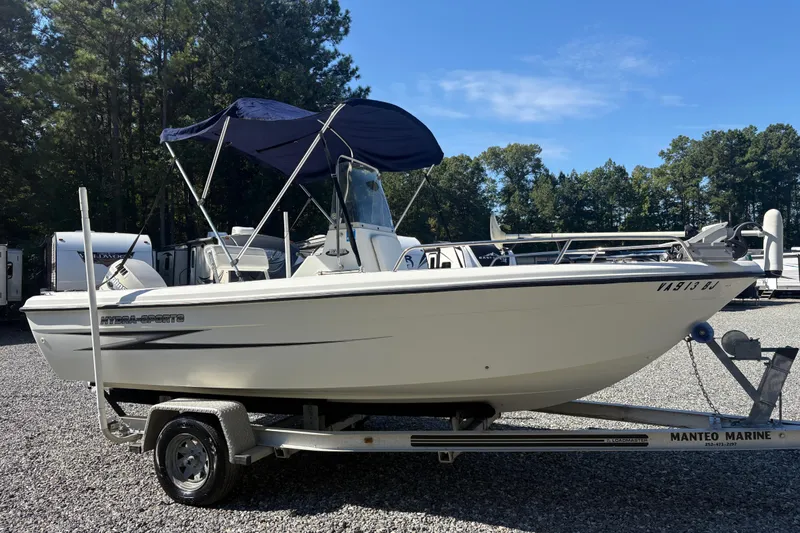 The Image of 2000 Hydra-Sports 180 Seahorse CC boat on trailer, parked outdoors. - 1