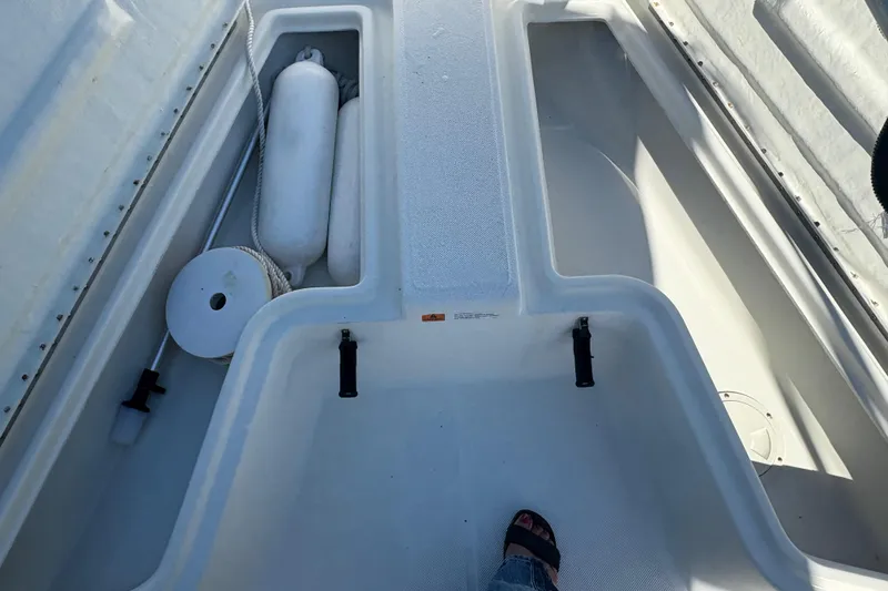 Slide: The Image of 2000 Hydra-Sports 180 Seahorse CC boat deck with storage compartments and marine equipment. - 15