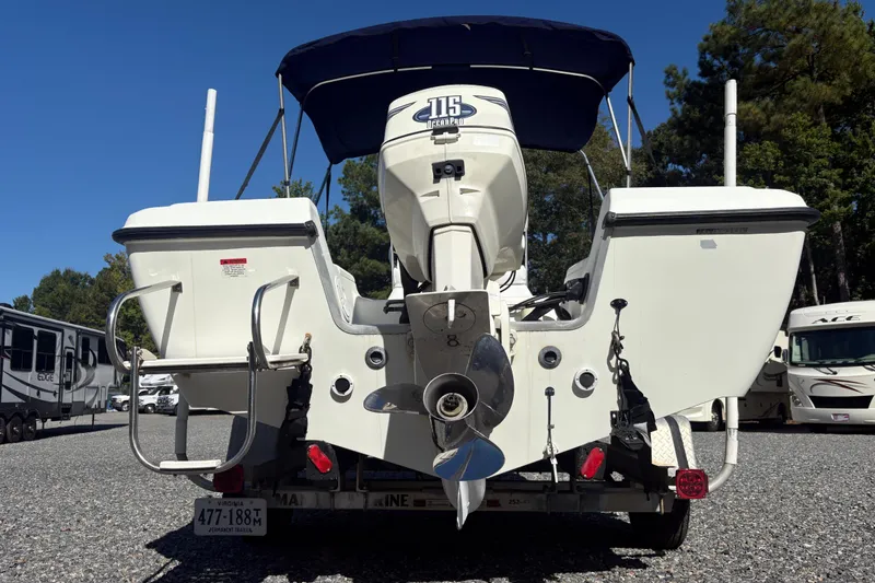 Slide: The Image of 2000 Hydra-Sports 180 Seahorse CC boat with outboard motor, parked on gravel lot. - 4