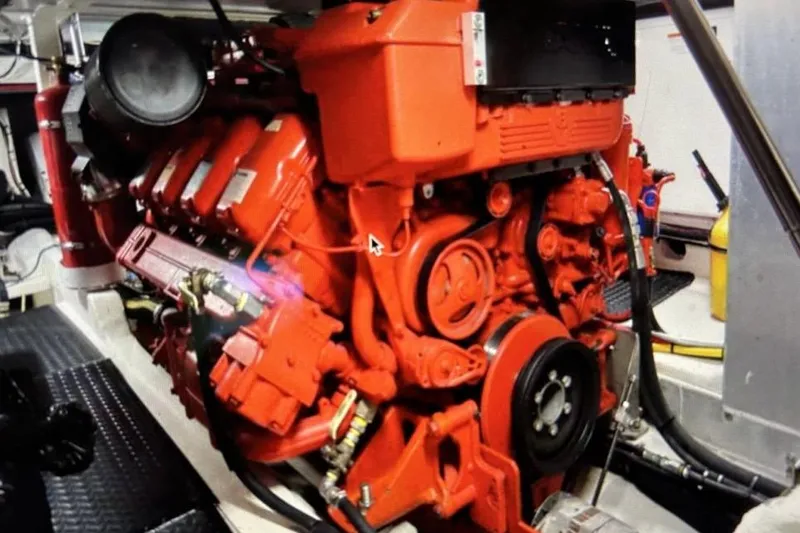 Slide: The Image of Red engine inside a 2018 Mussle Ridge 46 boat, showcasing mechanical components. - 12