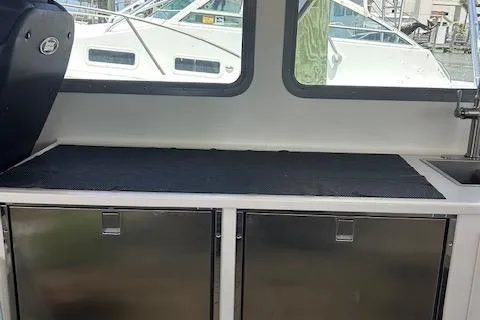 Slide: The Image of Interior view of a 2018 Mussle Ridge 46 boat with stainless steel cabinets. - 6