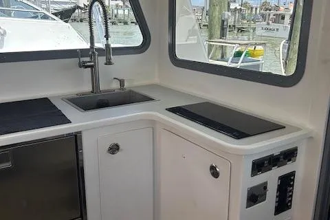 Slide: The Image of Modern kitchen area in 2018 Mussle Ridge 46 boat with sink and stove. - 7