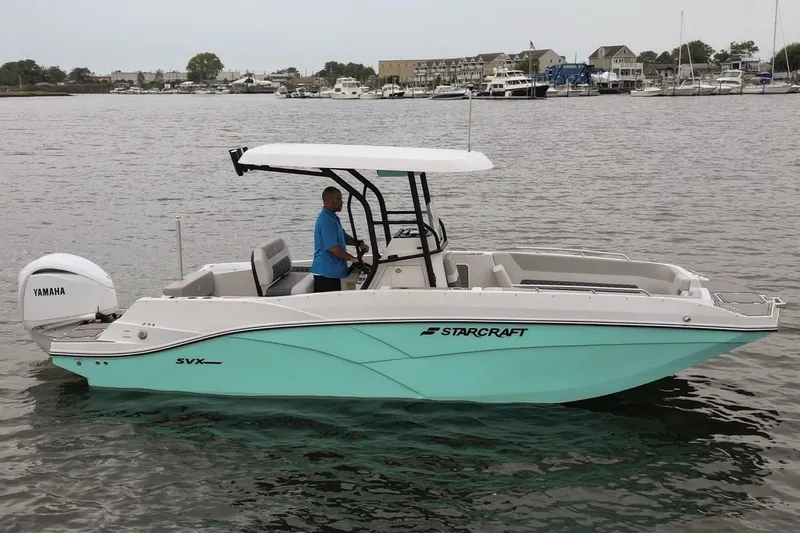 Slide: The Image of 2026 Starcraft SVX 231 OB CC boat on water, featuring Yamaha outboard motor. - 0