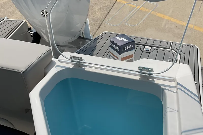 Slide: The Image of 2026 Starcraft SVX 231 OB CC boat interior with open storage compartment and flooring box. - 12