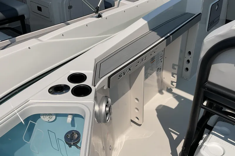 Slide: The Image of 2026 Starcraft SVX 231 OB CC boat interior with cup holders and storage compartments. - 17