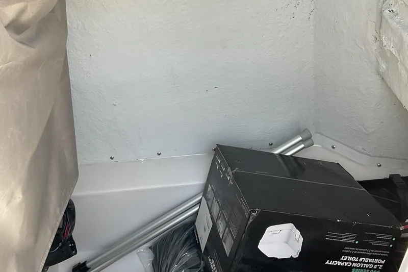 Slide: The Image of Storage area in 2026 Starcraft SVX 231 OB CC boat with portable toilet box. - 22