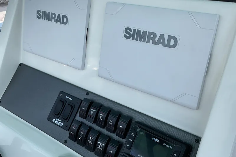 Slide: The Image of 2026 Starcraft SVX 231 OB CC dashboard with Simrad displays and control panel. - 4