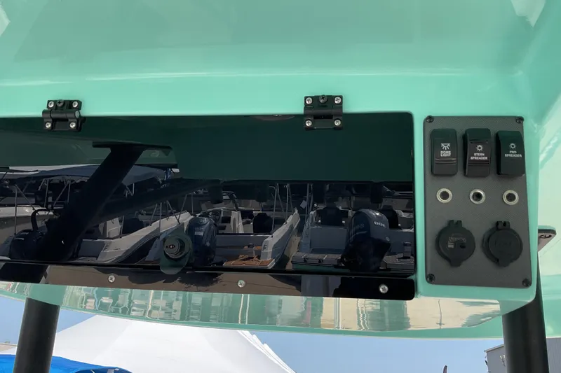 Slide: The Image of 2026 Starcraft SVX 231 OB CC boat dashboard with control switches and ports. - 6