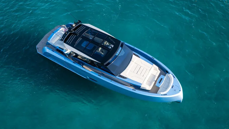 Slide: The Image of Aerial view of 2024 Vanquish Yachts VQ58 luxury yacht on clear blue water. - 2