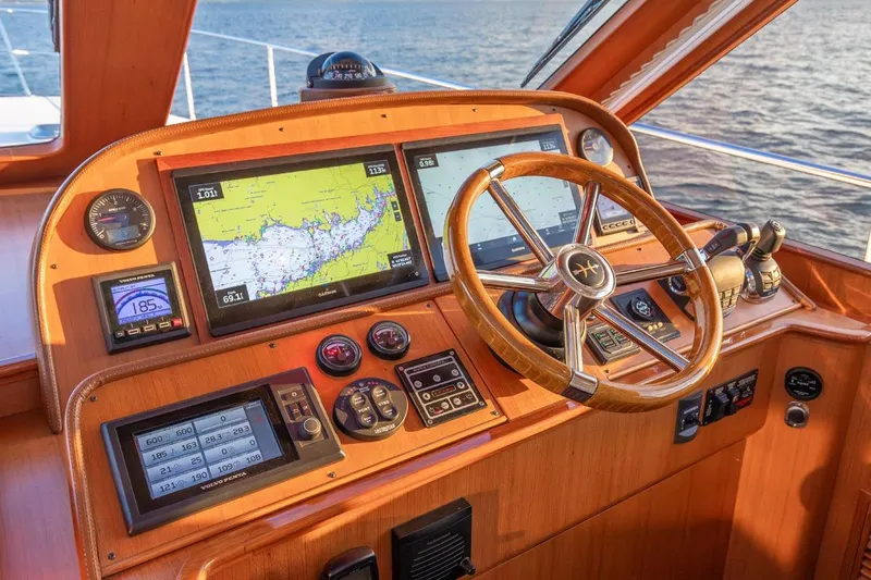 Slide: The Image of Helm of 2014 Hunt Yachts 44 with navigation screens and wooden steering wheel. - 17