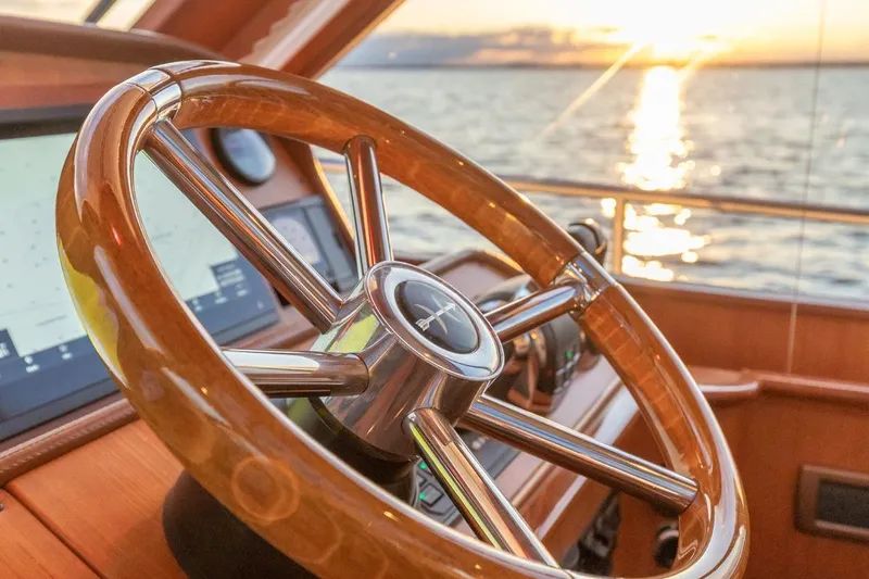 Slide: The Image of Steering wheel of 2014 Hunt Yachts 44 at sunset on the water. - 18