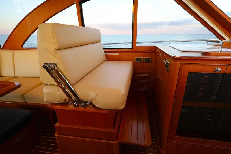 Slide: The Image of Luxurious interior of 2014 Hunt Yachts 44, featuring elegant seating and wooden finishes. - 21