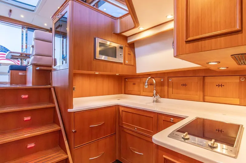 Slide: The Image of Luxurious 2014 Hunt Yachts 44 interior kitchen with wood cabinetry and modern appliances. - 23
