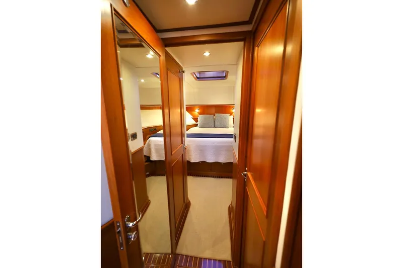 Slide: The Image of Luxurious cabin interior of 2014 Hunt Yachts 44, featuring elegant wood finishes and cozy bedding. - 25