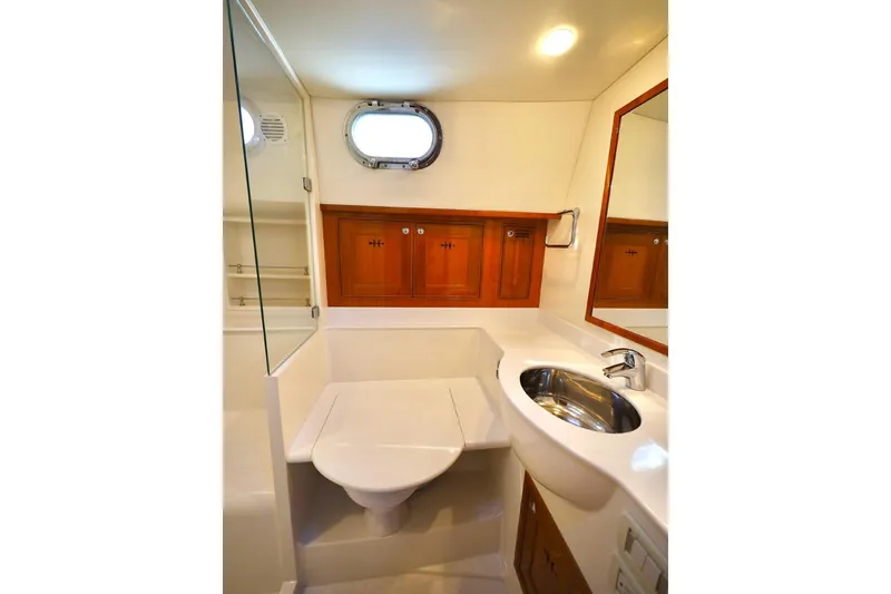 Slide: The Image of Luxurious bathroom in 2014 Hunt Yachts 44, featuring wooden cabinets and modern fixtures. - 27