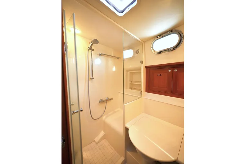 Slide: The Image of Luxurious bathroom in 2014 Hunt Yachts 44, featuring shower and wooden cabinetry. - 28