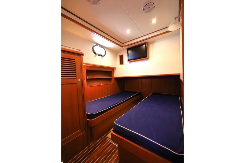 Slide: The Image of Luxurious cabin interior of 2014 Hunt Yachts 44 with twin beds and wooden finish. - 29
