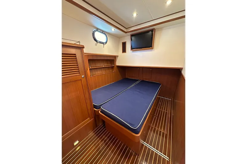 Slide: The Image of Cabin interior of 2014 Hunt Yachts 44 with wooden finish and blue cushions. - 30