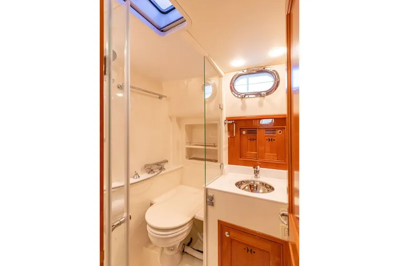 Slide: The Image of Luxurious bathroom in 2014 Hunt Yachts 44, featuring elegant wood accents and modern fixtures. - 31