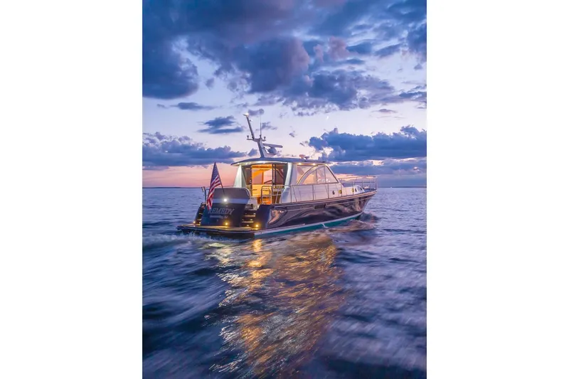 Slide: The Image of 2014 Hunt Yachts 44 cruising at sunset on open water. - 33