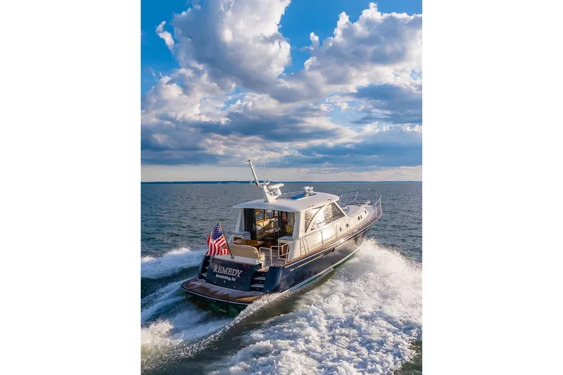 Slide: The Image of 2014 Hunt Yachts 44 cruising on open water under a partly cloudy sky. - 34