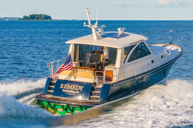 Slide: The Image of 2014 Hunt Yachts 44 cruising on open water with American flag. - 36