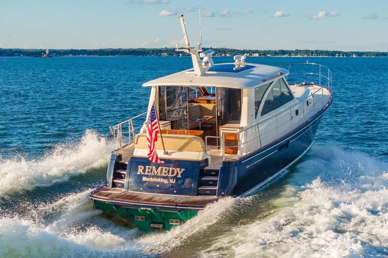 Slide: The Image of 2014 Hunt Yachts 44 cruising on open water, displaying American flag. - 4